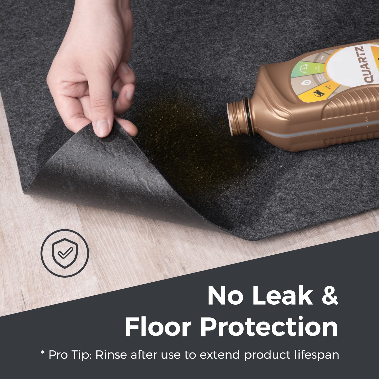 Accessory image for WELKIN Garage Floor Mat (A1204) demonstrating the 'No Leak & Floor Protection' feature. A hand lifts the corner of the mat with oil spilled on top, showing the wooden floor underneath remains dry.