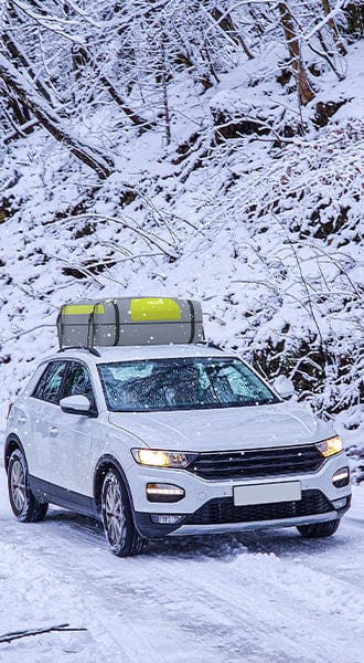 Homepage image showing a white RV at a sunny campsite with a black mesh awning shade screen providing side sun protection and privacy for the outdoor seating area.