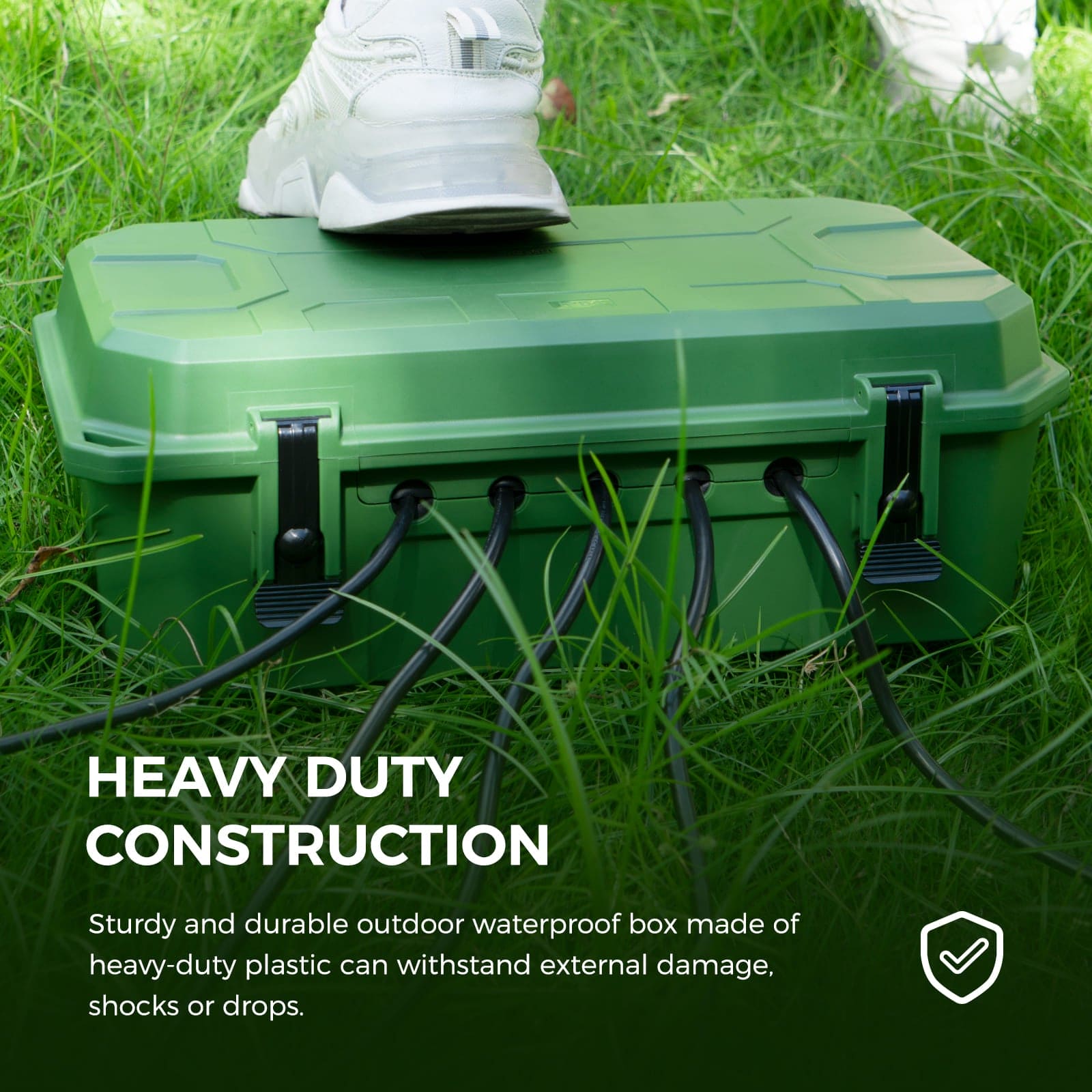 Accessory image for the WELKIN Outdoor Connection Box (R1105). A green box on the grass showing its heavy-duty construction, designed to withstand external damage, shocks, or drops.