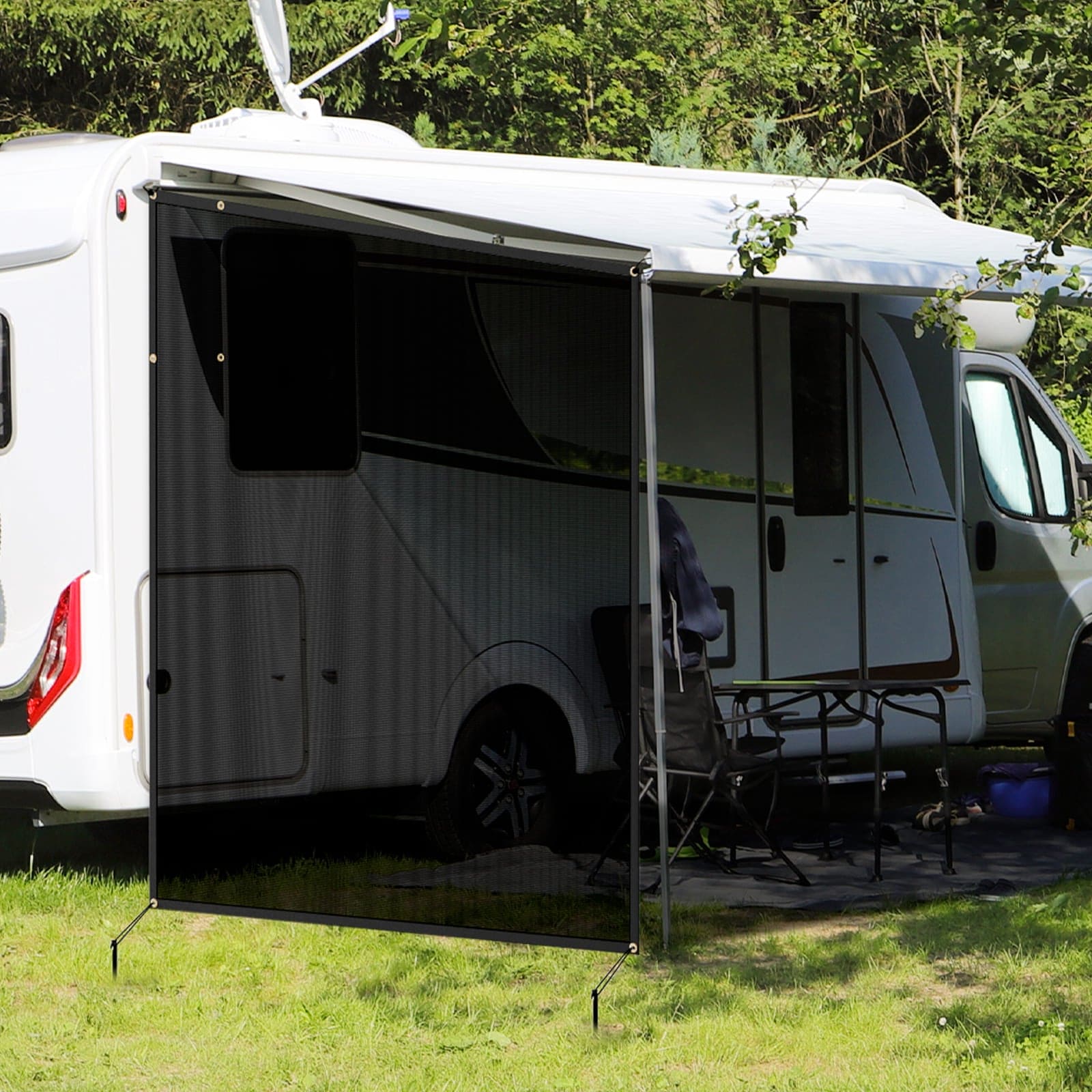 Outdoor use scene of the WELKIN Side RV Awning (A3201), showing the black mesh shade screen installed on the side of a white RV to create a shaded camping area with outdoor furniture.
